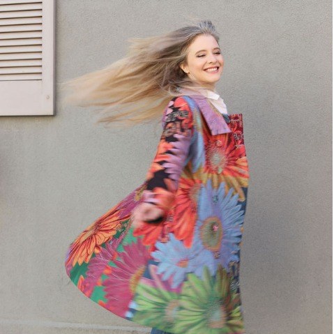 Jenilyn mid-twirl in a floral coat